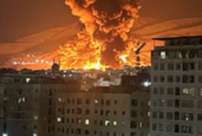 An oil depot in Tehran on fire after a strike