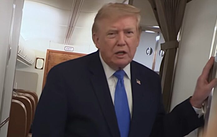 President Donald Trump speaking to reproters aboard Air Force One